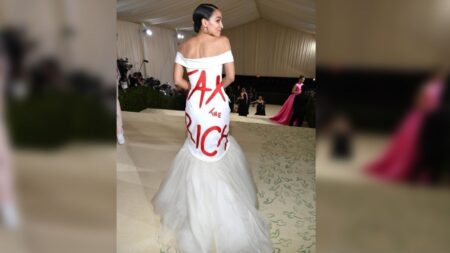 Alexandria Ocasio-Cortez meets the Met Gala with words 'Tax the Rich' splashed across a white Brother Vellies gown
