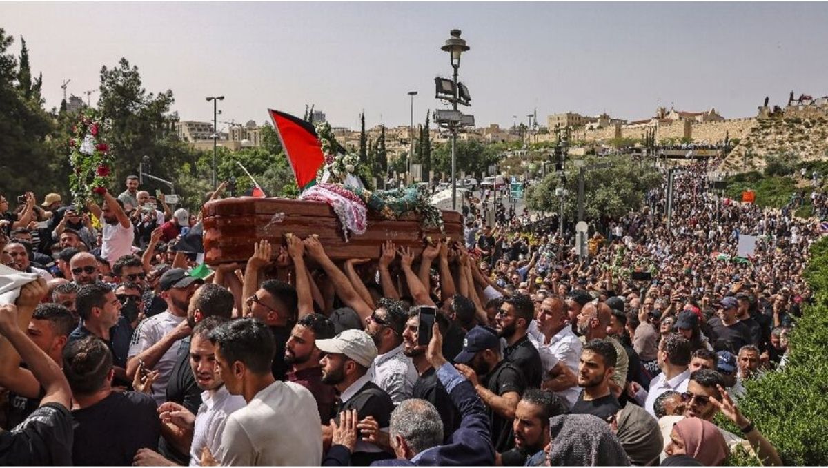 Israeli police beat mourners at the funeral of a slain Palestinian journalist
