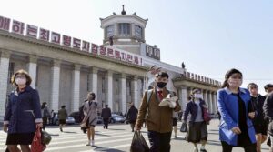 DPRK citizens seen in masks across a Pyongyang square