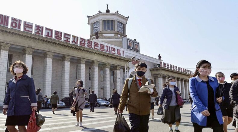 DPRK citizens seen in masks across a Pyongyang square