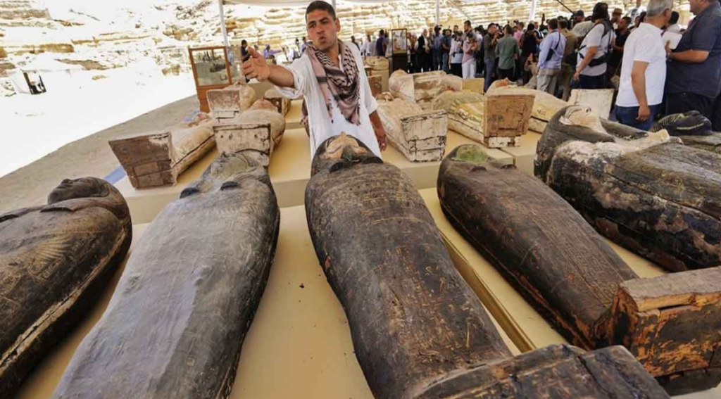 Archaeologists working near Cairo have uncovered hidden coffins, statues & coins