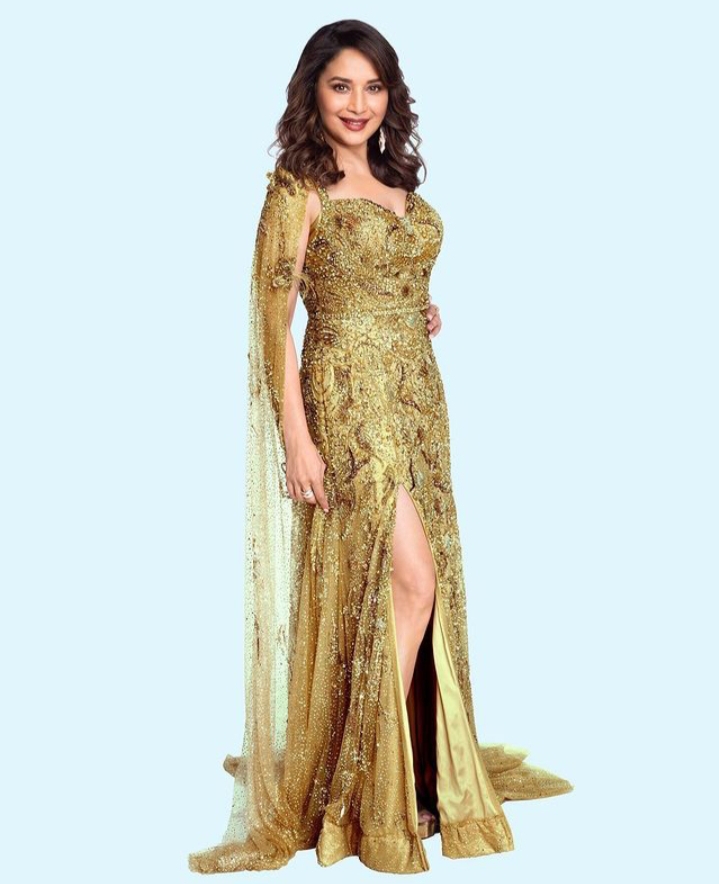 Madhuri Dixit shines in a golden thigh high slit gown .