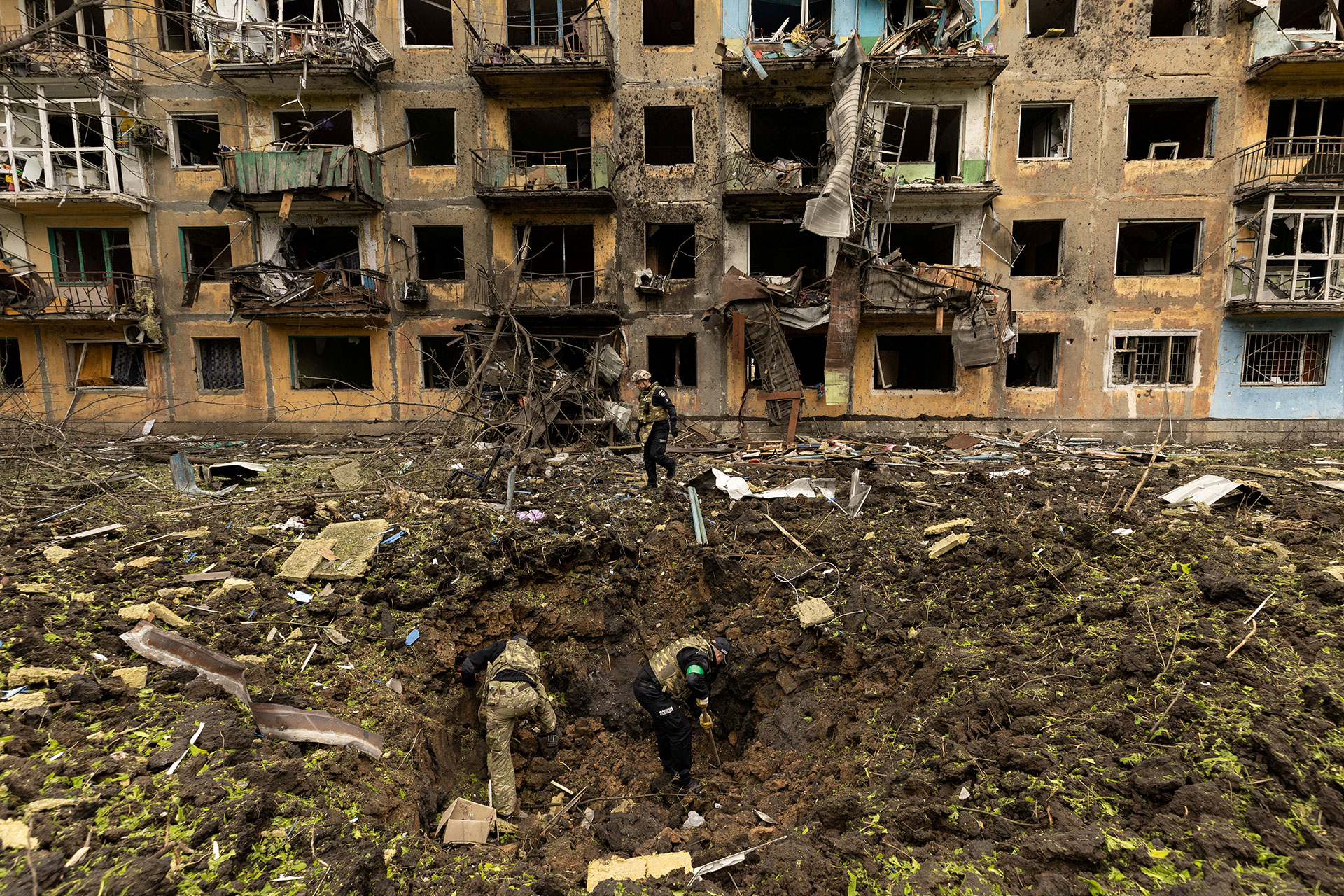 Ukrainians exploring a Russian missile struck complex in Dobrophillia, Ukraine, Reuters