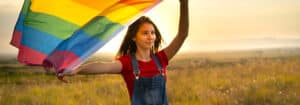 Girl holding a rainbow flag