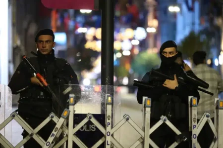 Police officers stand at the entrance to Istanbul's popular pedestrian Istiklal Avenue, late on Sunday, November 13, 2022 [Emrah Gurel/ AP]