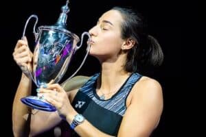 Garcia kissing the WTA Finals 2022 trophy