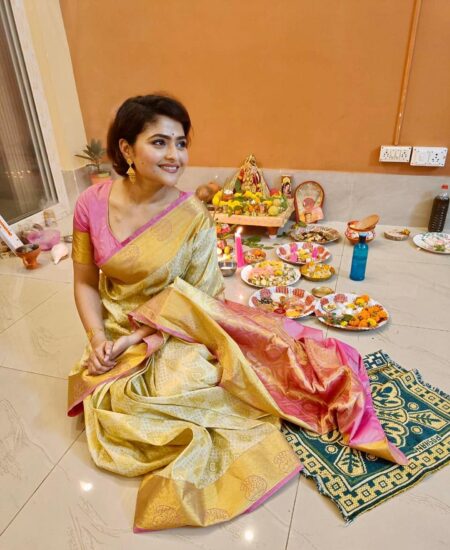 aindrila sharma is sitting in the floor wearing a saree
