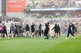 Three charged after Melbourne derby pitch invasion - Asiana Times