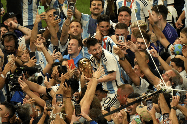 Upon winning the World Cup, large crowds embrace the Argentina team.