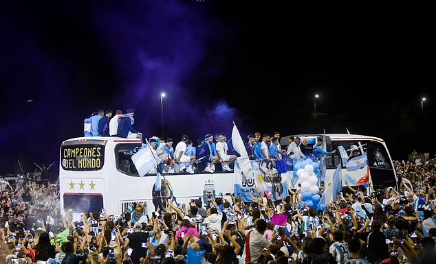 Upon winning the World Cup, large crowds embrace the Argentina team.