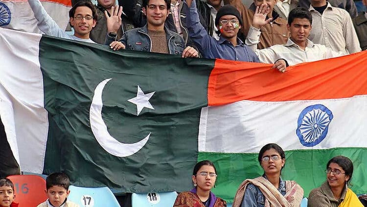Indian and Pakistani fans enjoying a cricket match together.