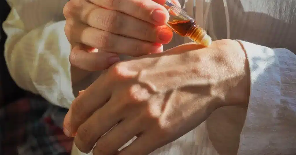 man applying attar on his hand