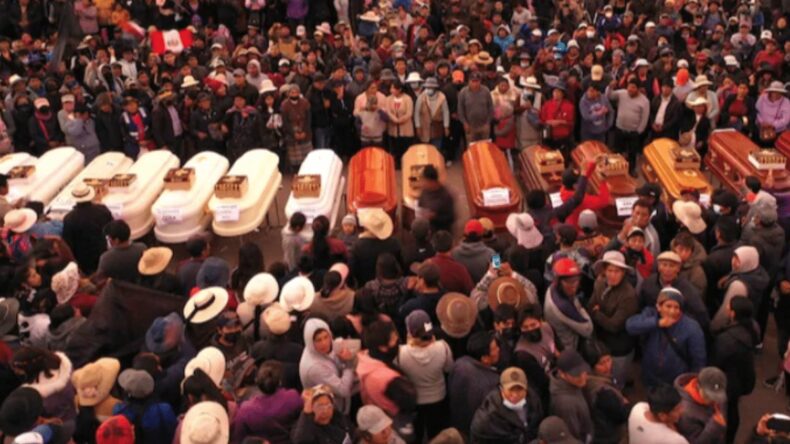 People with coffin outside a hospital in Peru