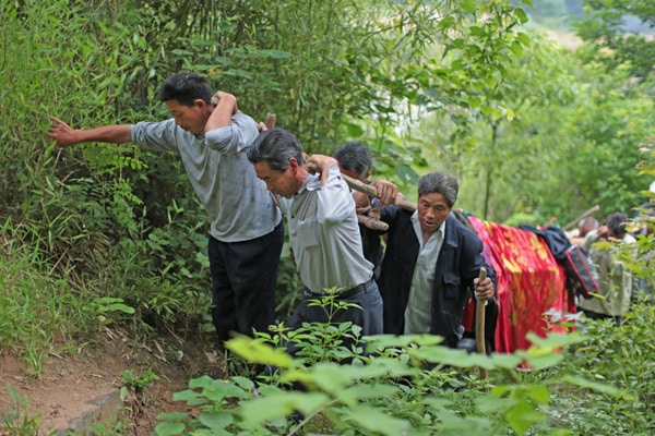 people of China carrying something on their back