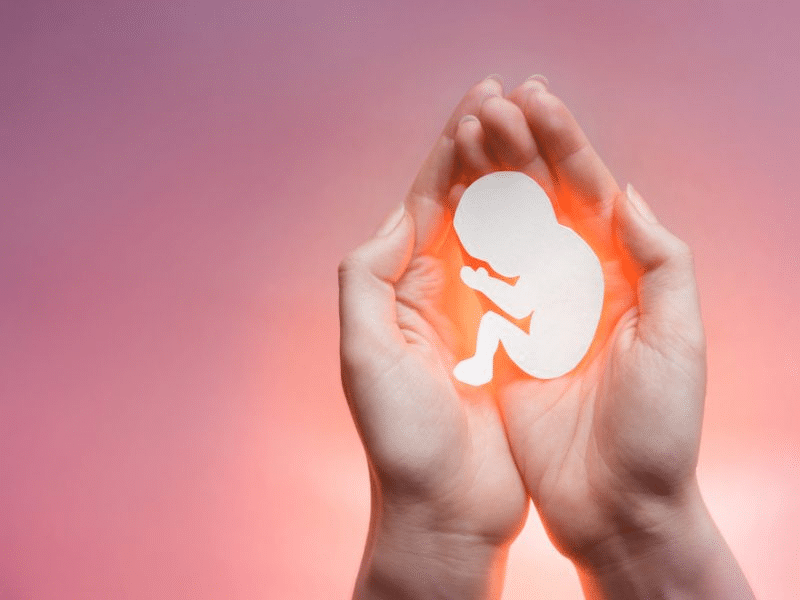 illustration of a baby glowing in the palm of a woman's hands
