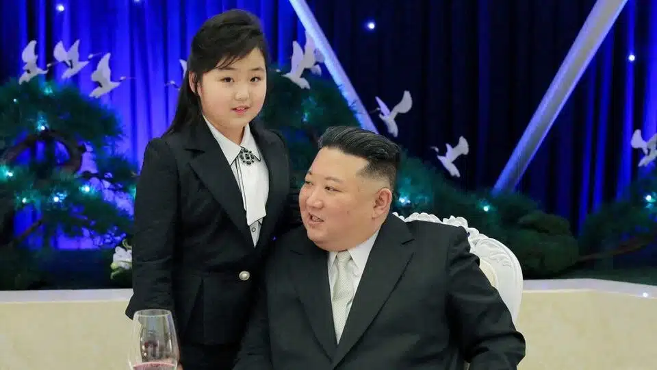 Kim Jong Un talks to his daughter Kim Ju at the banquet.