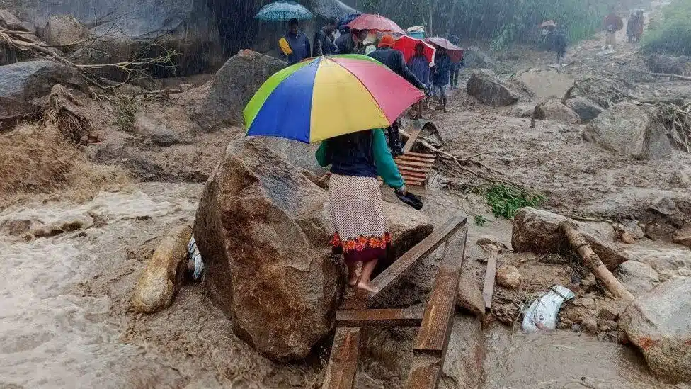 People crossing poor areas in cyclone-hit Malawi. 


