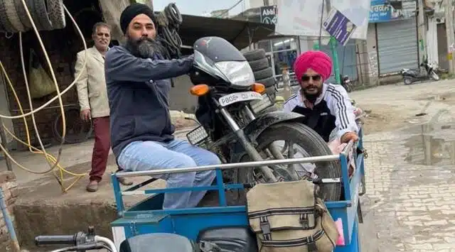 Amritpal Singh and Papalpreet singh with a motorbike.