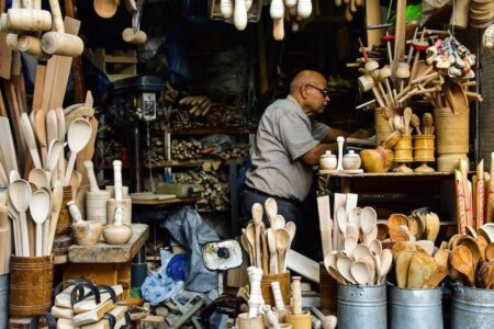 A Man in a Store of Wooden Assorted Items