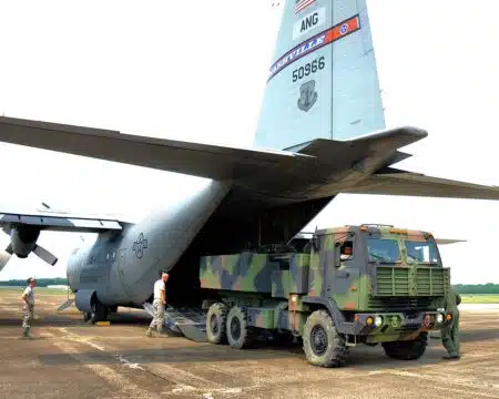 A C-130 Transport Aircraft unloading a HIMARS.