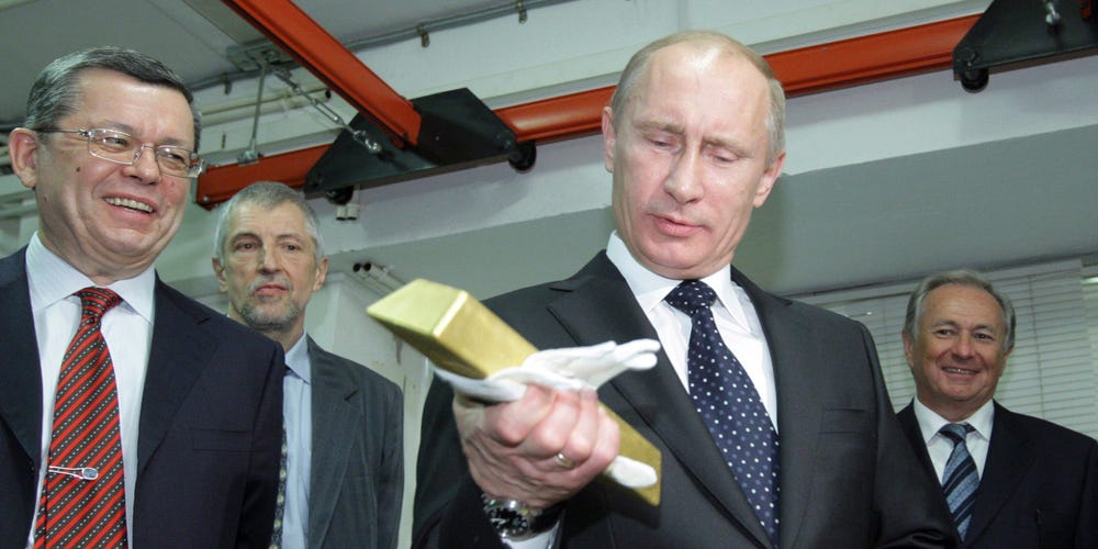 Russian president Vladimir Putin with a gold bullion in hand.