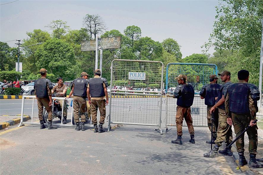 Security officials in Pakistan close a road outside former PM Imran Khan’s Lahore residence on Thursday.