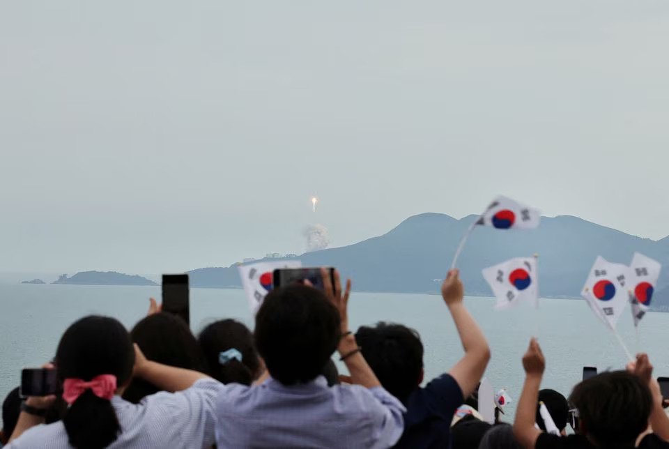 People watch the launch of South Korea’s homegrown Nuri space rocket in Goheung, South Korea.
