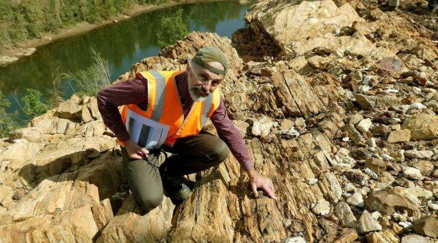 (The inspection of fossils near a water source in Australia, sourced from Reuters)