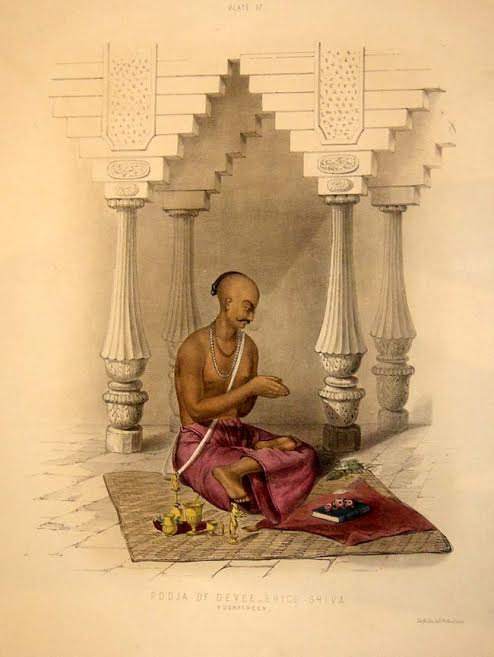 Image depicting a priest performing pooja.