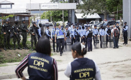 This image shows the police force being present in the Honduran Prison