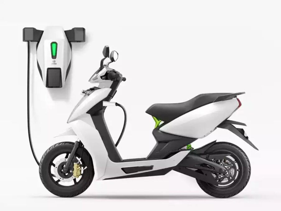 Electric 2-wheeler getting charged from a charging point. 