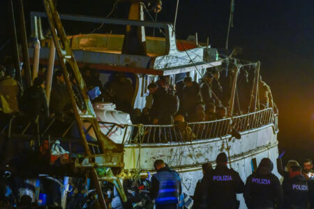 heck a fishing boat with some 500 migrants in the southern ltalian port of Crotone, early Saturday, March 11, 2024. The Italian coast guard was responding glers boats carrying more than 1,300 migrants "in danger off Italy's southern coast, officials said Friday. Three small coast guard boats were rescuing a boa ants about 70 nautical miles off the Calabria region, which forms the toe of the ltalian boot. (AP Photo/Valeria Ferraro)