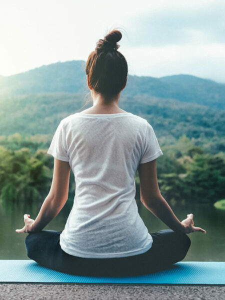 Full Length Of Woman Doing Yoga Against Lake