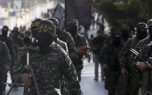 Members of the Al-Quds Brigades, the military wing of the Islamic Jihad terrorist group, march with their weapons to show loyalty for the Iranian-backed Palestinian movement's newly elected leader Ziad al-Nakhalah during a rally in Gaza, October 4, 2018. (AP Photo/Adel Hana)