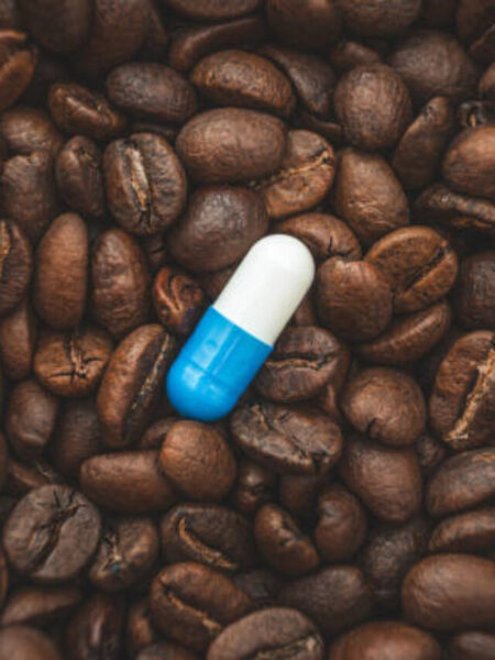 pill on the background of coffee beans.