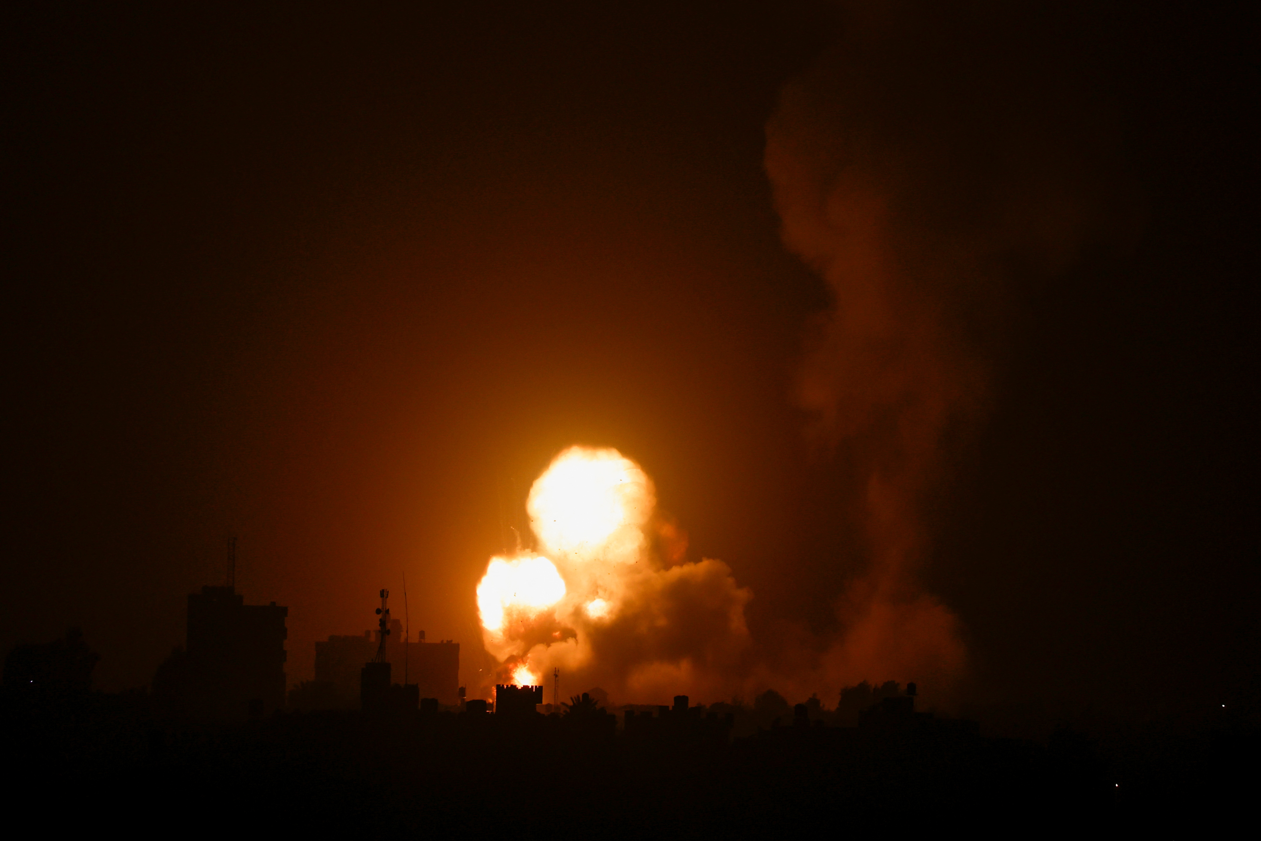 Flames and smoke rise during Israeli air strikes amid a flare-up of Israel-Palestinian violence, in the southern Gaza Strip