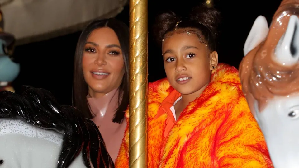Kim Kardashian and North West in her orange outfit featured in Kanye West's music video.