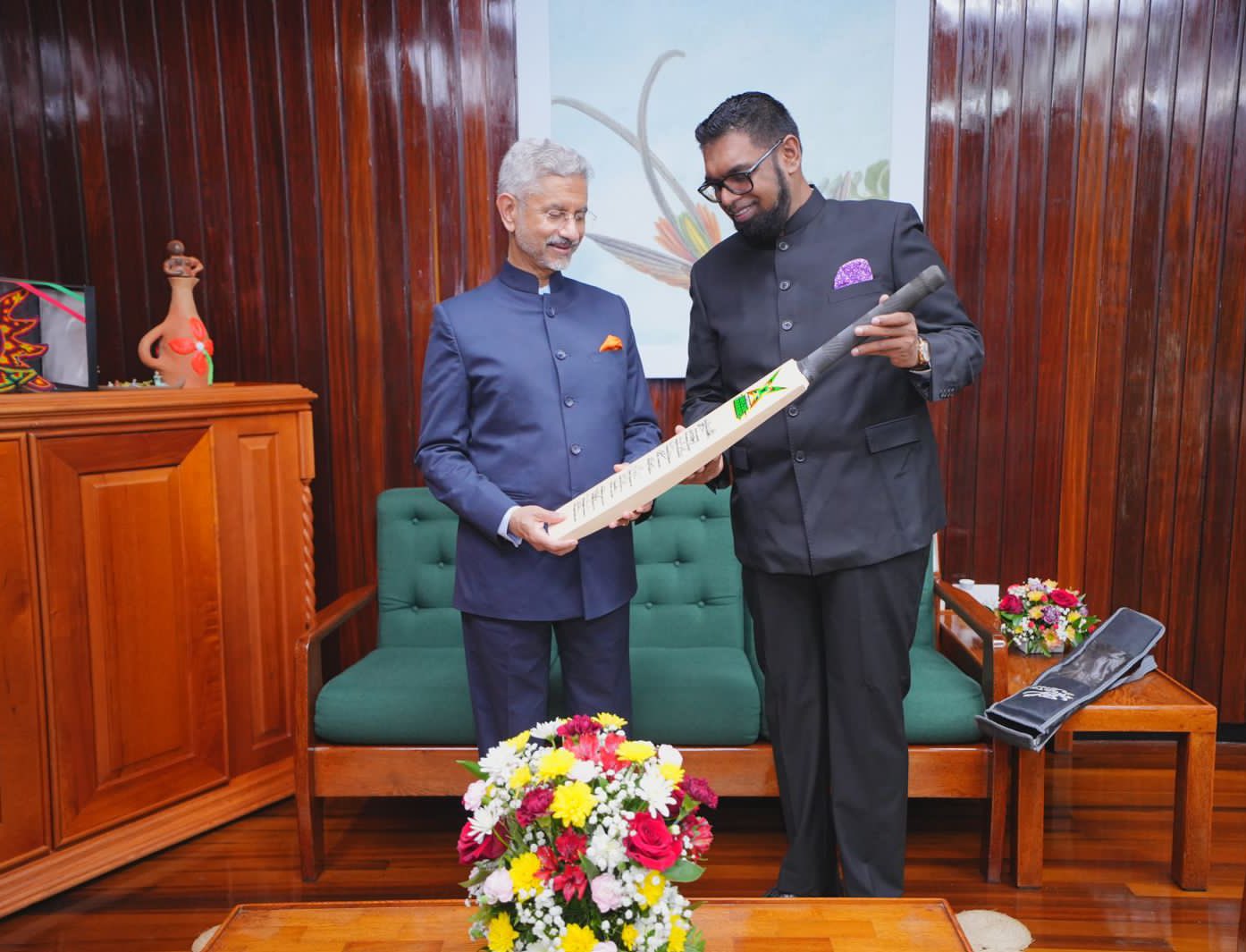 The Indian EAM received a benevolent gift of a cricket bat and a jersey with his name on it from the president and the vice president.