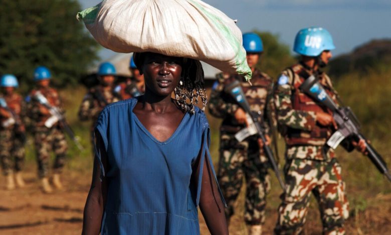 Sudan Refugees with UN peacekeepers in the background