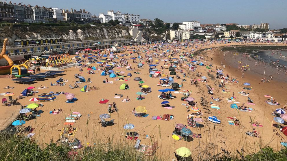 People flock to Broadstairs beach in Kent, England, Thursday July 25, 2019. Paris and London and many parts of Europe are bracing for record temperatures as the second heat wave this summer bakes the continent. The Paris area could be as hot as 42 C 