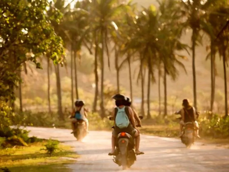 Tourists in Goa renting bikes to travel. 