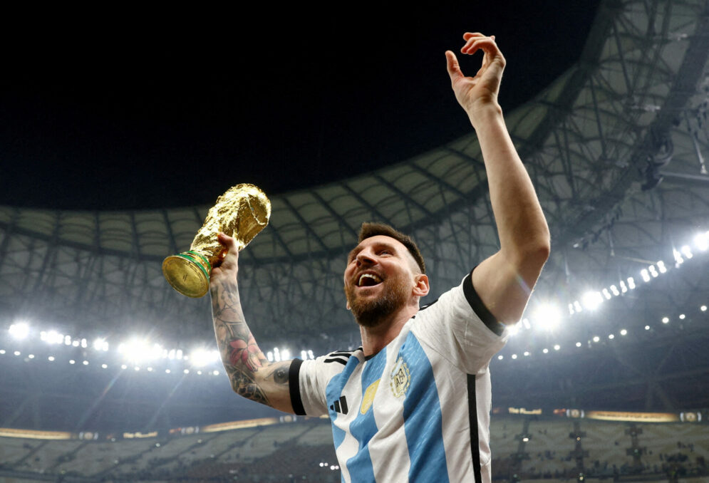 Messi with the World Cup trophy