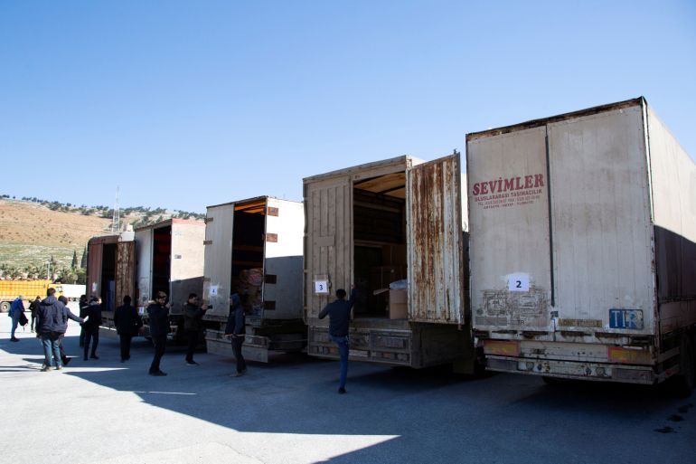 Trucks carrying humanitarian aid are seen at the Bab al Hawa border crossing from Turkey