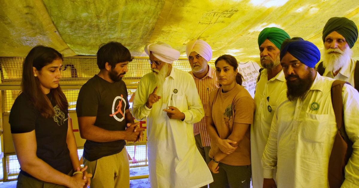 Wrestlers protesting at Jantar Mantar in Delhi on Monday speaking with farmer leader Balbir Rajewala.