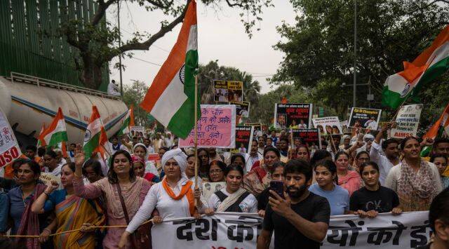 Wrestler Bajrang Punia records on his mobile phone as he joins India's top female wrestlers and their supporters in a march towards India Gate monument on Tuesday.