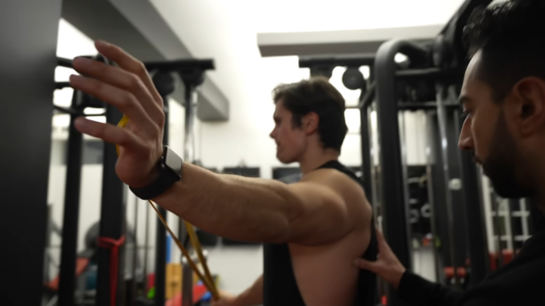 Personal Trainer Instructing a Client on Proper Form at A Gym, Enhancing Workout Effectiveness